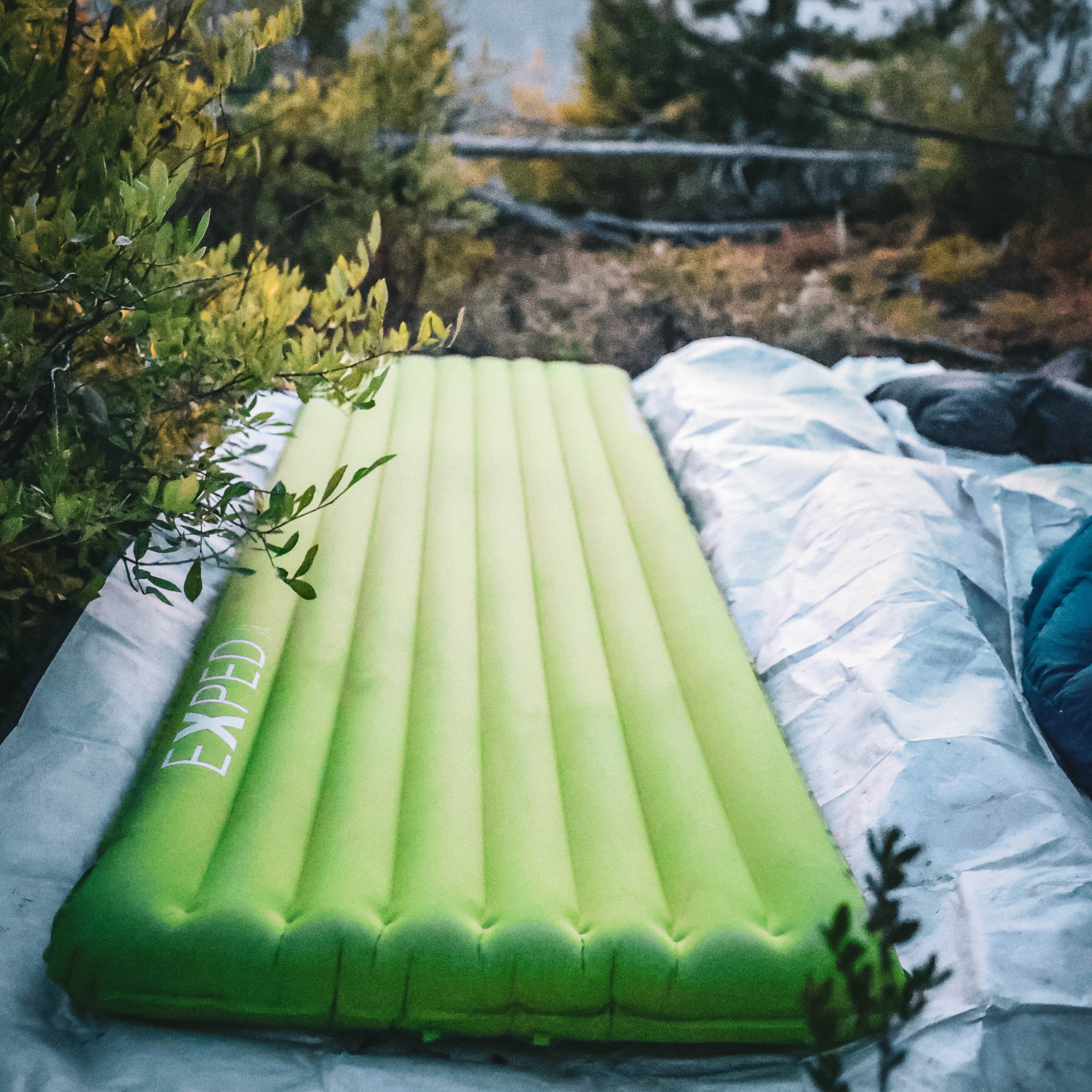 a green exped sleeping mat